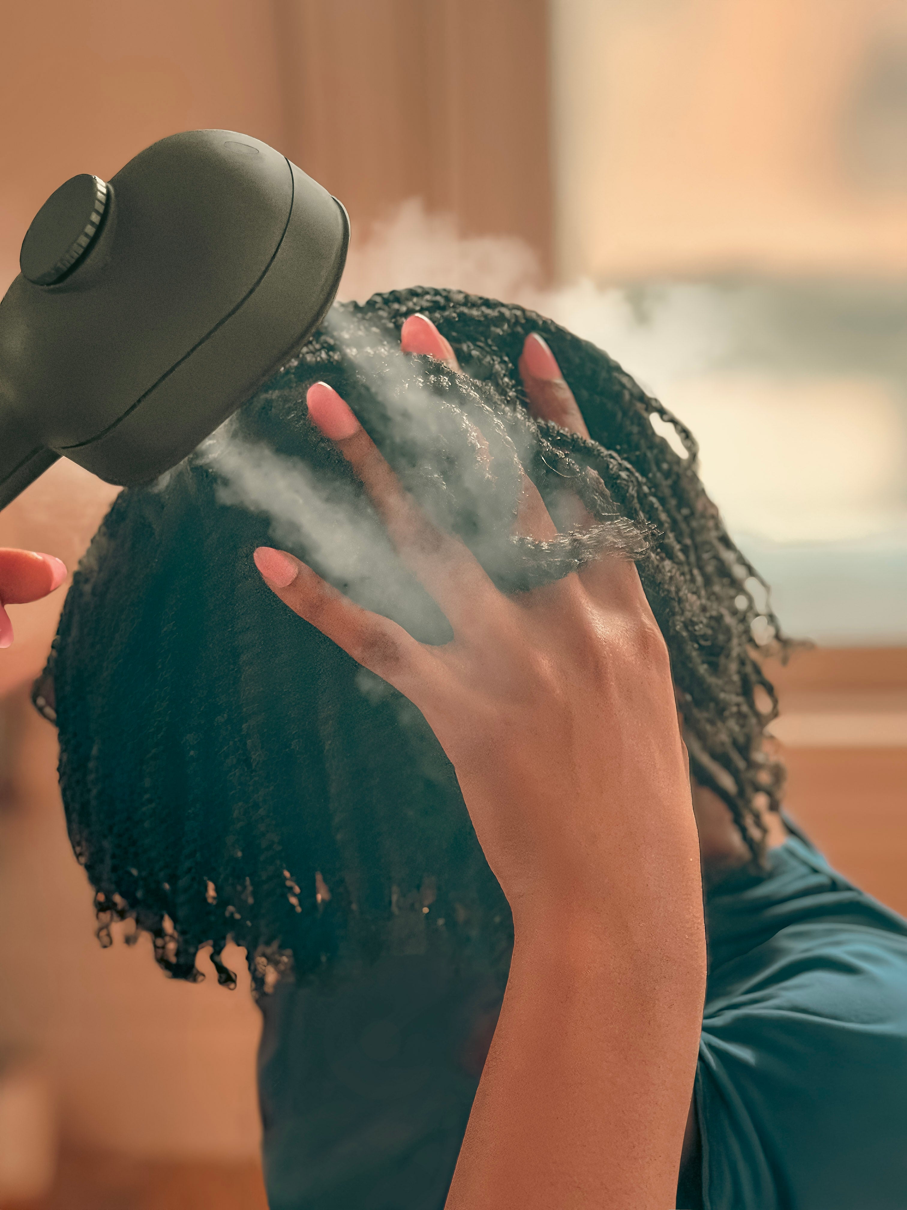 Person using mimi ultrasonic to hydrate hair